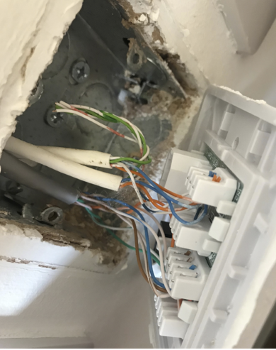 Behind copper socket in cupboard