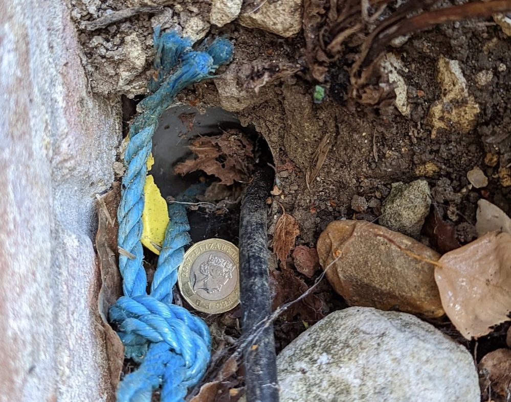 Tubing and copper cable - £ for scale. Rope was tied by person who came to find it.